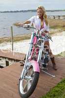 Sexy Blond Woman In Bikini and Shorts on Chopper Motorbike