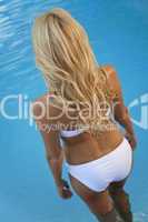 Sexy Blond Woman in White Bikini Walking Into Swimming Pool
