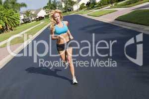 Beautiful Blond Woman Running In Suburban Street