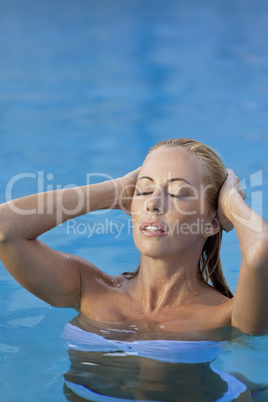 Sexy Blond Woman in White Bikini Emerging From Swimming Pool
