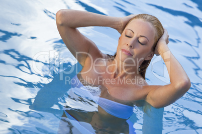 Sexy Blond Woman in White Bikini Emerging From Swimming Pool