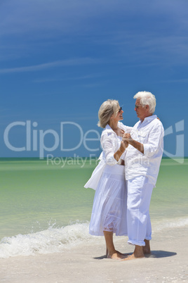 Happy Senior Couple Dancing Holding Hands on A Tropical Beach