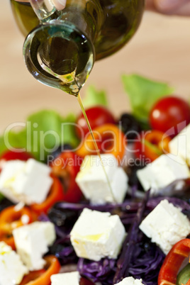 Olive Oil Dressing Pouring Onto Fresh Salad