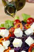 Olive Oil Dressing Pouring Onto Fresh Salad