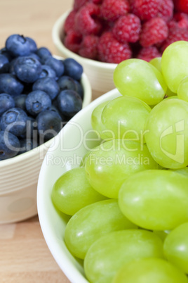 Bowls of Healthy Grapes, Blueberries and Raspberries