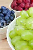 Bowls of Healthy Grapes, Blueberries and Raspberries