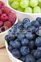 Bowls of Healthy Breakfast Blueberries Raspberries and Grapes