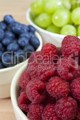 Bowls of Healthy Raspberries Blueberries & Grapes