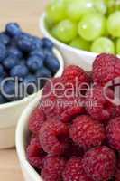 Bowls of Healthy Raspberries Blueberries & Grapes