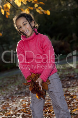 Beautiful Mixed Race African American Girl Playing With Fall Lea