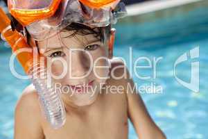 Happy Boy In A Swimming Pool with Goggles and Snorkel