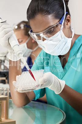 Asian Female Scientist Using Pipette and Blood Sample In Laborat