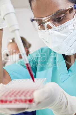 Asian Female Scientist Using Pipette and Blood Sample In Laborat