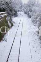 Snow Covered Railway Tracks and Stop light