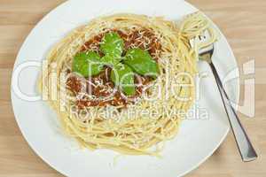 Spaghetti Bolognese With Basil Garnish and Grated Parmesan Chees
