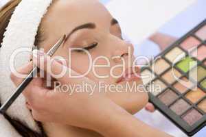 Beautiful Woman Having Make Up Applied by Beautician at Spa