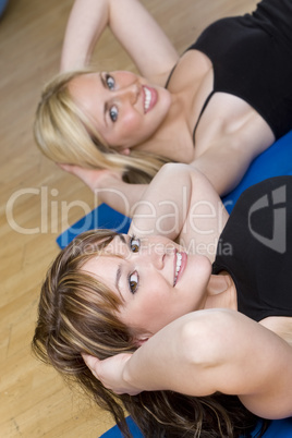 Two Beautiful Young Woman Aerobic Exercising At A Gym