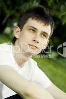 Young man sits in the park