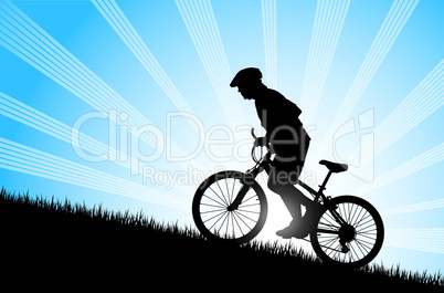 Biker riding up to hill