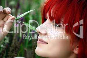 Redhead girl posing with a flower