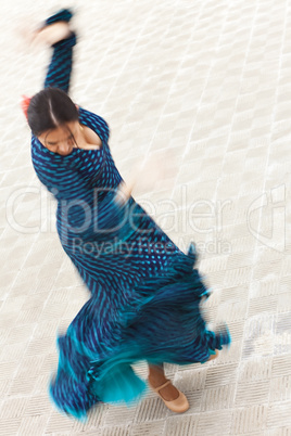 Motion Blurred Shot of Spinning Woman Spanish Flamenco Dancer