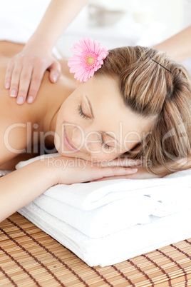 Smiling young woman receiving a back massage