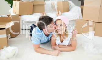 Enamored couple relaxing after moving