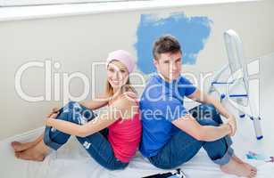 Young couple painting a room