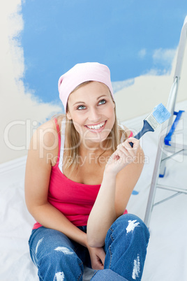 Cheerful woman  painting a room
