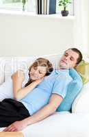 Affectionate couple sleeping lying on a sofa
