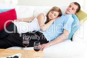 Loving couple sleeping lying on a sofa