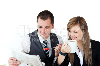 Confident couple of business people having breakfast