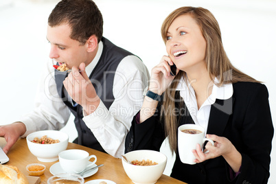 Young couple of business people having breakfast
