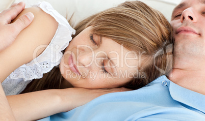 Close-up of a young couple sleeping lying on a sofa