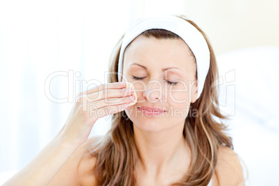 Portrait of a relaxed woman putting make-up