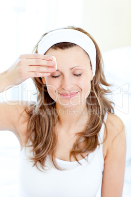 Portrait of a smiling woman putting make-up