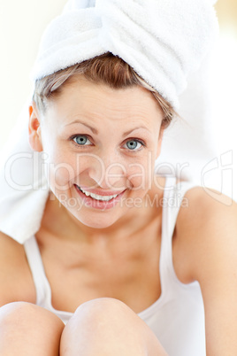 Cheeful woman wearing a towel