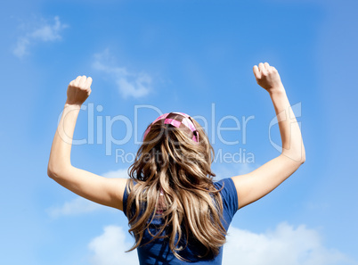 Portrait of a  blond woman punching the air