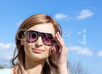 Attractive blond woman with sunglasses outdoors