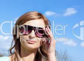 Attractive blond woman with sunglasses outdoors