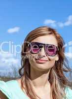 Smiling blond woman with sunglasses outdoors