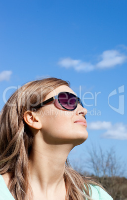 Relaxed blond woman with sunglasses outdoors