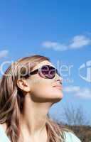 Relaxed blond woman with sunglasses outdoors