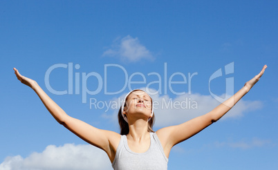 Radiant woman relaxing against blue sky