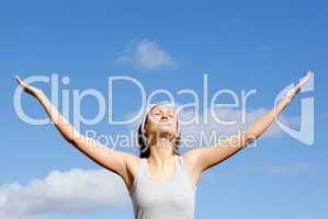 Peaceful woman relaxing against blue sky