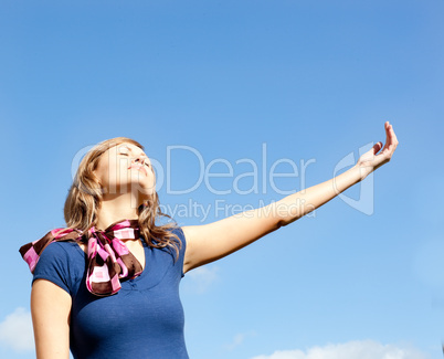 Young  blond woman against blue sky