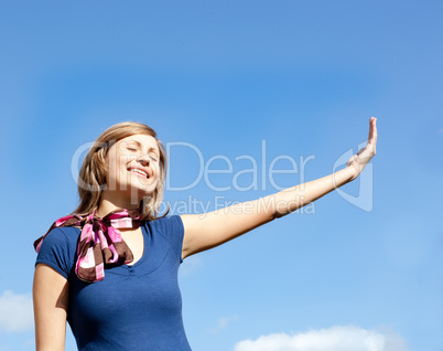 Jolly  blond woman against blue sky