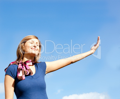 Cheerful  blond woman against blue sky