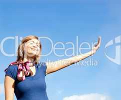 Cheerful  blond woman against blue sky