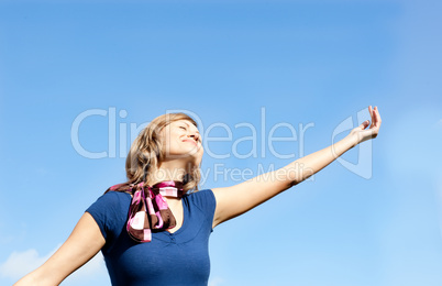 Smiling  blond woman against blue sky